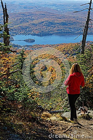 Young woman admires landscape during fall season from Mont Tremblant Editorial Stock Photo