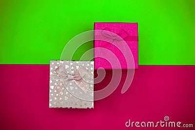 Plastic pink and silver gift boxes on a trend color background Stock Photo