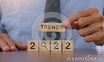 2022 trend concept.business idea over wooden cube.Businessman holding wooden with year 2022 plans and copy space Stock Photo