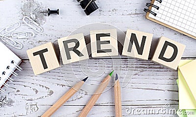 TREND text on wooden block with office tools on the wooden background Stock Photo