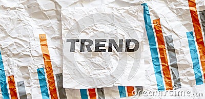 TREND word text on the white memo note crupled sticker on chart background Stock Photo