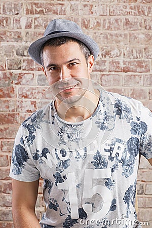 Trendy adult man portrait on background brick wall. Stock Photo