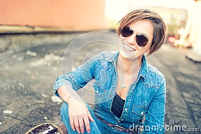 Trendy brunette girl, smiling and laughing against orange background, isolated. Hipster instagram girl smiling at camera Stock Photo