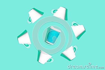 Coffee pattern is made from blue paper cup for coffee and white ceramic cups on bright mint background Stock Photo