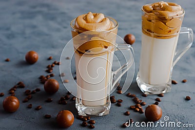 Trendy, trendy Dalgon coffee drink made from vegetable or regular milk with coffee foam. Two glasses stand on a black background Stock Photo