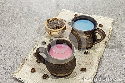 Trendy drink blue and pink latte. Lavender or spirulina and rose, beetroot or raspberry coffee. Stone concrete background Stock Photo