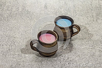 Trendy drink blue and pink latte. Lavender or spirulina and rose, beetroot or raspberry coffee. Stone concrete background Stock Photo