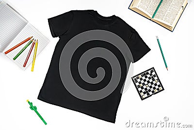 Trendy fashion T-shirt black styled basic clothes and accessories collection on white background. Flat lay, top view. Chess, book Stock Photo