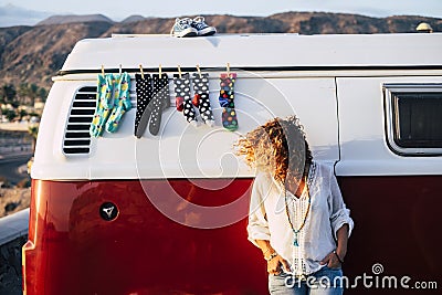 Trendy fashion young woman people outside a cozy and beautiful vintage retro van with socks and shoes - perfect vanlife travel Stock Photo