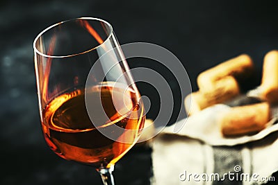 Trendy food and drink, orange wine in glass, gray table background, space for text, selective focus Stock Photo