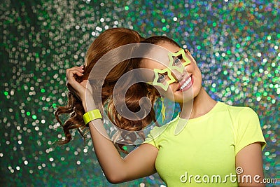 Trendy girl with bright green neon accessories. Model in a disco nightclub. Woman at a theme party in the rays of light Stock Photo