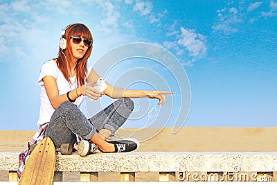 Trendy girl listens to music with smartphone Stock Photo