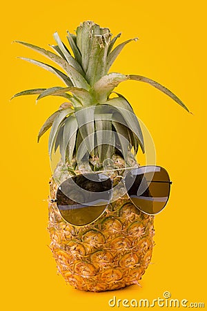 Trendy glasses summer pineapple wearing hipster style on yellow Stock Photo