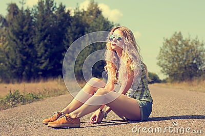 Trendy Hipster Girl Sitting on the Road Stock Photo