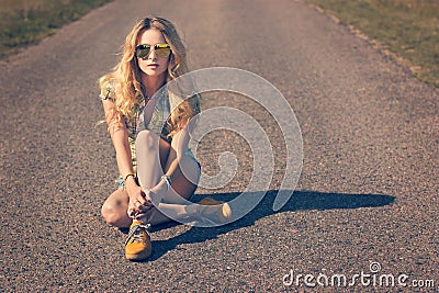 Trendy Hipster Girl Sitting on the Road Stock Photo