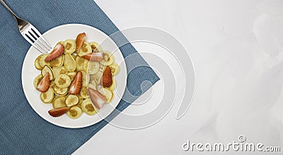 Trendy home breakfast with tiny pancakes, bananas and strawberry and fork on a colored towel. View from above. Free space for text Stock Photo
