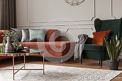 Trendy living room interior with brown corner sofa with pillows and blanket in fashionable living room interior Stock Photo