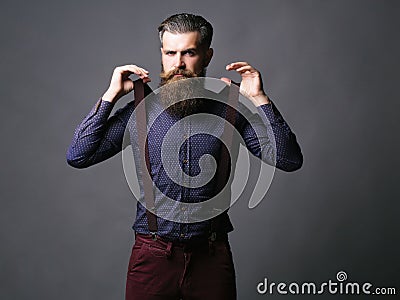 Trendy man pulls suspenders Stock Photo
