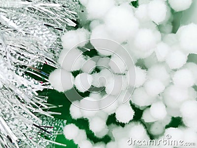 Trendy silver tinsel, and white cotton balls. Natural flax fabric and spruce branch background. blurred background, selective Stock Photo