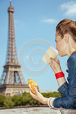 Trendy solo traveller woman having coffee cup and croissant Stock Photo