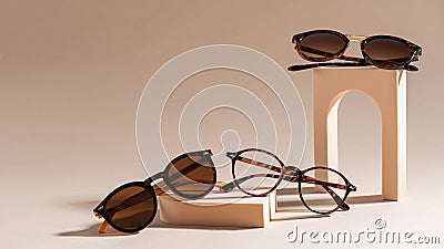 Trendy sunglasses of different design and eyeglasses on beige background. Copy space. Sunglasses and spectacles sale concept. Stock Photo