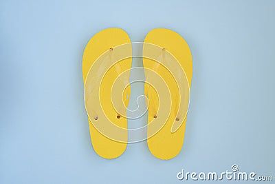 Trendy sunlight Summer composition. Beach flip-flops on a bright light blue background. Stock Photo