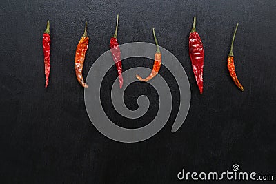 Trendy ugly hot chili peppers seamless pattern on a black background, Contrast, top view, square, trend, ugly, unusual Stock Photo
