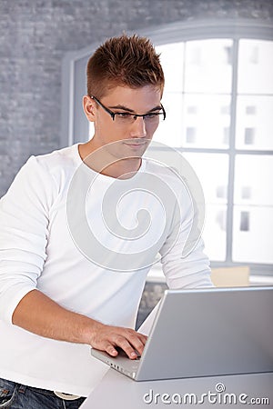 Trendy young man with laptop Stock Photo