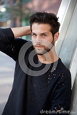 Trendy young man posing with hand in hair Stock Photo