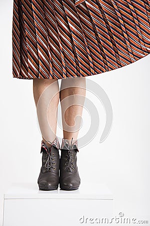 Trendy young woman`s legs flitting skirt. Stock Photo