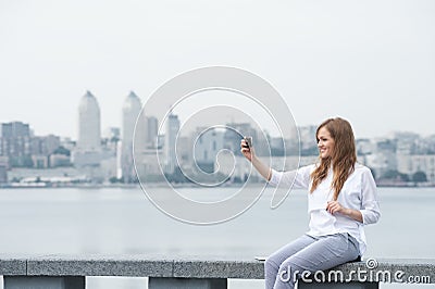 Trendy young woman taking a selfie in the city11 Stock Photo