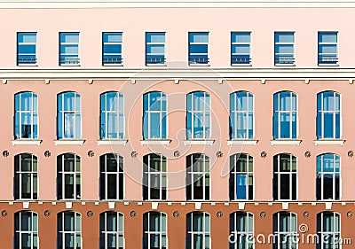 Tri-color facade with high windows. Architectural details Stock Photo