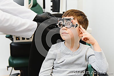 Trial frame. Glasses for a little boy. Hypermetropia. Ametropia correction with glasses Stock Photo