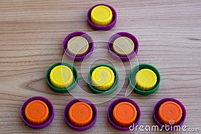 Triangle of colorful plastic lids Stock Photo