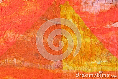 Triangle pattern on stitched orange silk batik Stock Photo