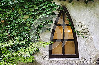 Triangle window on an old grunge wall Stock Photo