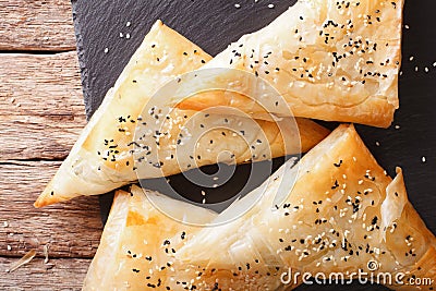 Triangles of phyllo pastry stuffed with chicken, spinach and che Stock Photo