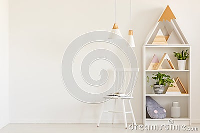 Triangles on shelves in scandi kid`s room interior with white ch Stock Photo