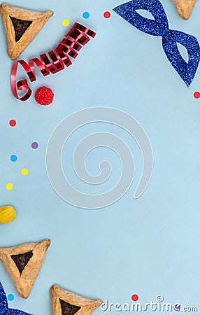 Triangular cookies with poppy seeds hamantasch or aman ears , candy, glitter mask, serpentine for jewish holiday of purim Stock Photo