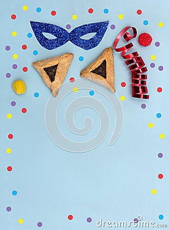 Triangular cookies with poppy seeds hamantasch or aman ears , candy, mask, serpentine, confetti for jewish holiday of purim Stock Photo