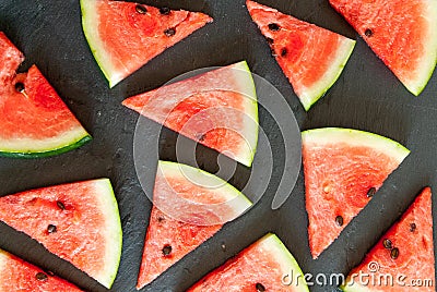 Triangular pieces of water melon spread on black Stock Photo