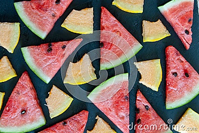 Triangular pieces of water melon spread on black Stock Photo
