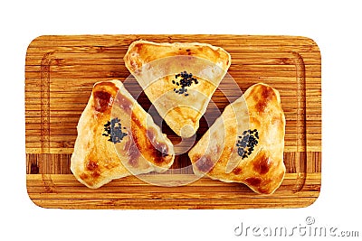 Triangular pies of puff pastry on a wooden background Stock Photo