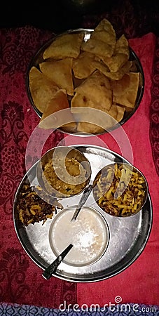 A triangular puri with khir bhujiya is best for breakfast or dinner in madhubani India Stock Photo