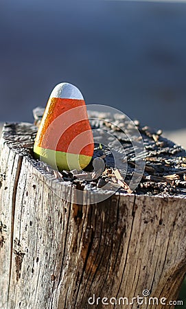 Triangular rock painted to look like candy corn Stock Photo