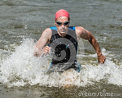 Triathlete comming out ot the water Stock Photo