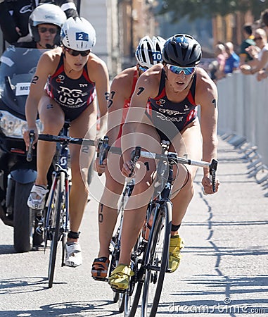 Triathlete Katie Zaferes cycling, followed by competitors Editorial Stock Photo