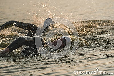 Triathletes swim on start of the Ironman triathlon competition Editorial Stock Photo