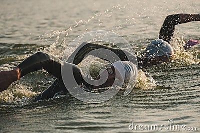 Triathletes swim on start of the Ironman triathlon competition Editorial Stock Photo
