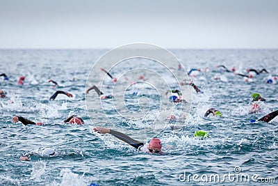 Triathletes in water in the Ironman triathlon competition at Calella beach Editorial Stock Photo